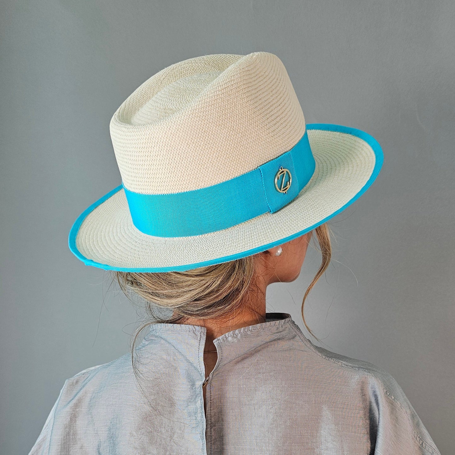 ISA classic Panama hat - sophisticated side profile showcasing handwoven Montecristi craftsmanship and aqua ribbon detail
