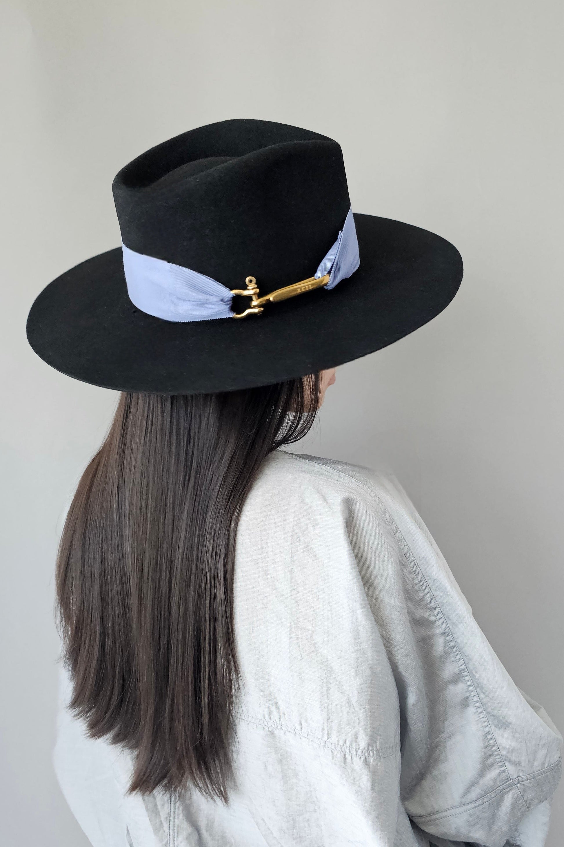 Side profile of black & periwinkle fedora displaying elegant silhouette and hand-crafted quality