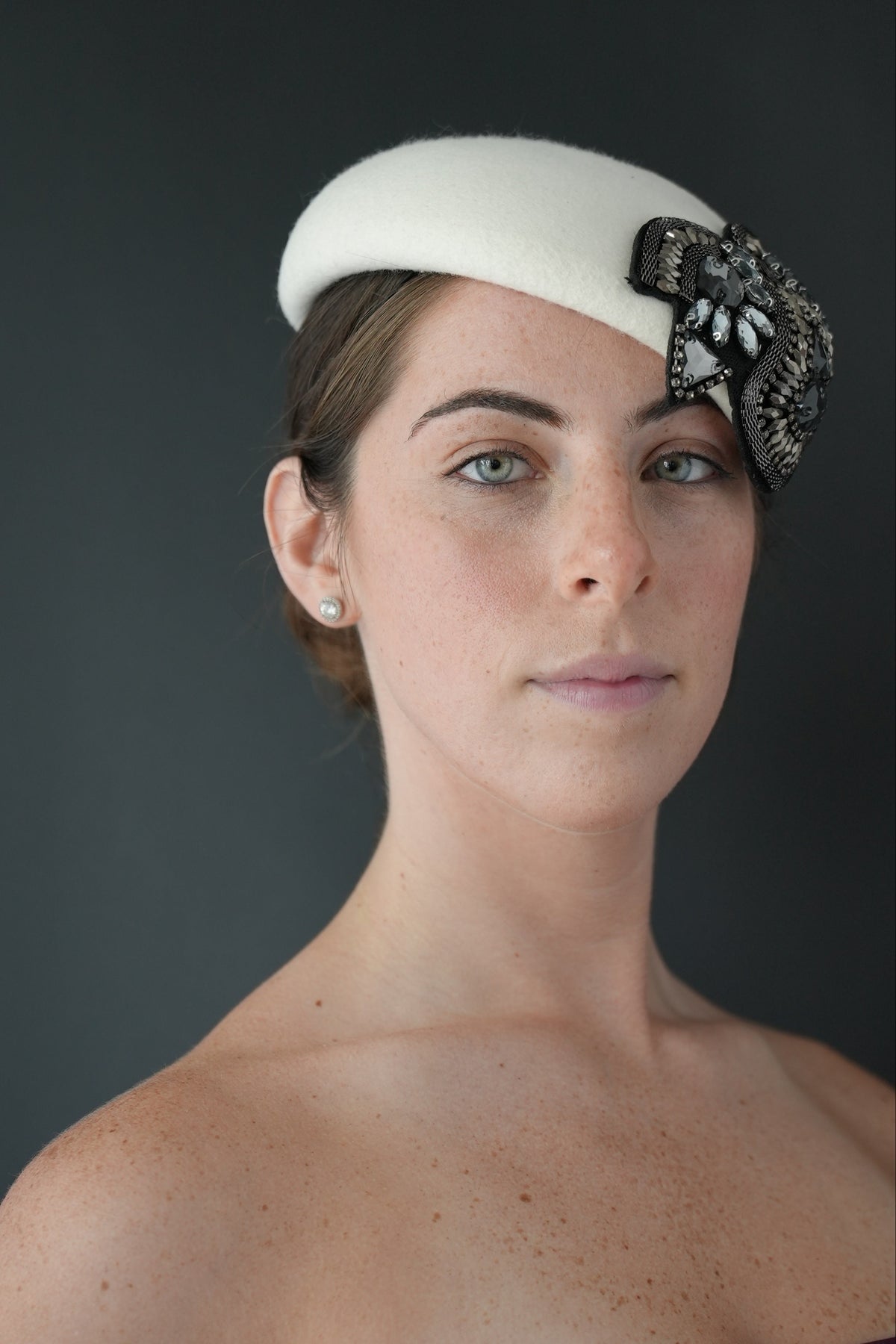 Bianca - white felt Percher hat with a black and silver jeweled embellishment,