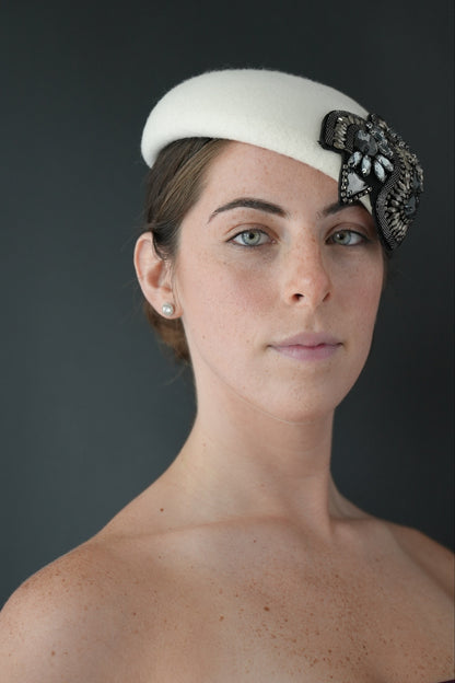 Bianca - white felt Percher hat with a black and silver jeweled embellishment,