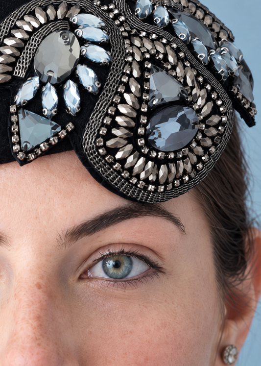 Simone Percher Hat Close up. 
Black felt hat adorned with large, ornate silver and white rhinestone brooch.
