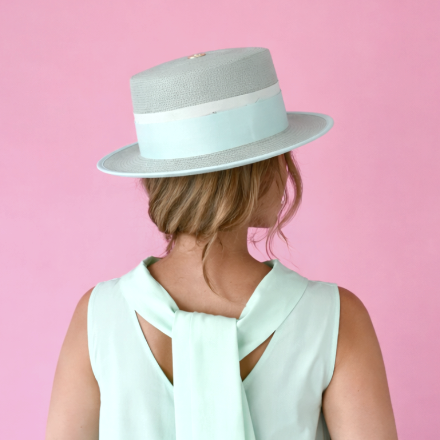 Model in ALMA seafoam green boater hat with white and mint ribbon detail - back view