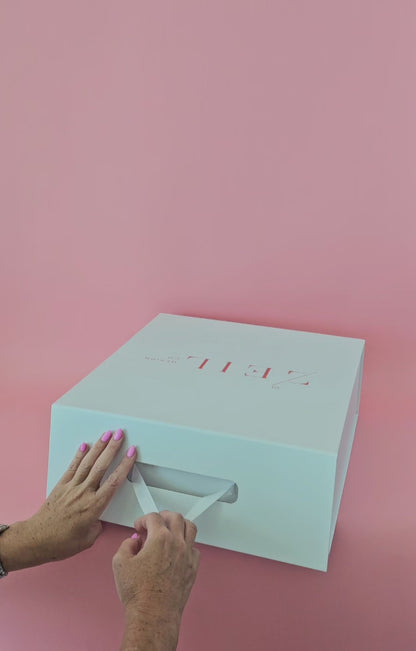 Video of MIA black boater hat being unboxed, revealing handcrafted open-weave design and red petersham ribbon detail